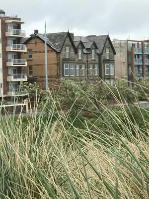 a large building in a city with tall grass at Beach Lookout - SEA VIEWS in Lytham St Annes