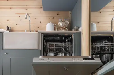 a kitchen with an oven with dishes in it at Orchard Glamping in Catterall