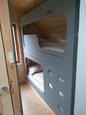a small bedroom in a tiny house at Orchard Glamping in Catterall