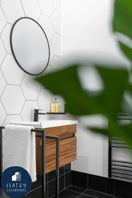 a bathroom with a sink and a mirror at FLATZY - Victoria Street Apartment - Heart of City Centre in Liverpool
