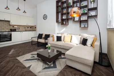 a living room with a couch and a table at FLATZY - Victoria Street Apartment - Heart of City Centre in Liverpool