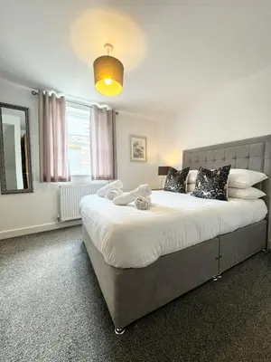 a bedroom with a large bed and a large window at The Kipling Inn, 4 - Bed, Sleeps 7, Pets Welcome in Ulverston