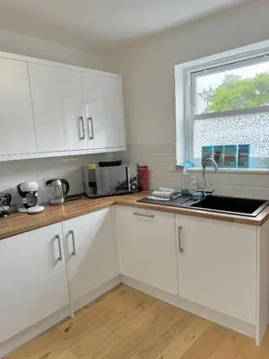 a kitchen with white cabinets and a window at The Kipling Inn, 4 - Bed, Sleeps 7, Pets Welcome in Ulverston