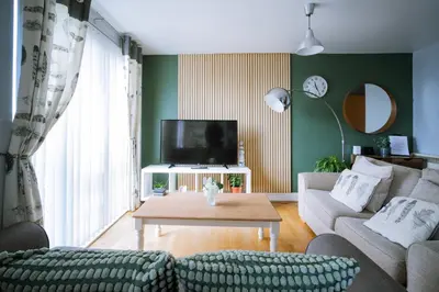 a living room with a couch and a tv at Modern central Penthouse - 1 FreeParking in Liverpool