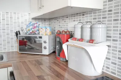a kitchen with a counter with a microwave and appliances at Modern central Penthouse - 1 FreeParking in Liverpool