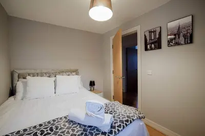a bedroom with a bed with two towels on it at Modern central Penthouse - 1 FreeParking in Liverpool