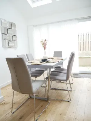 a white dining room with a white table and chairs at The Birketts Inn, 4 - Bed, Sleeps 8, Pets Welcome in Ulverston