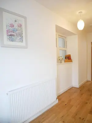 an empty living room with white walls and wooden floors at The Birketts Inn, 4 - Bed, Sleeps 8, Pets Welcome in Ulverston