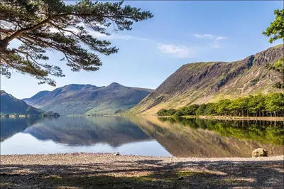 a view of a lake with mountains in the background at The Birketts Inn, 4 - Bed, Sleeps 8, Pets Welcome in Ulverston