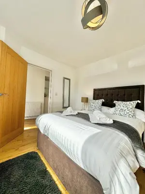 a bedroom with a large bed with white sheets at The Birketts Inn, 4 - Bed, Sleeps 8, Pets Welcome in Ulverston