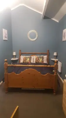 a bedroom with a wooden bed in a room at Atlantic cottage in Blackpool