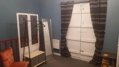 a dressing room with a mirror and some curtains at Atlantic cottage in Blackpool