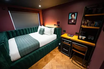 a bedroom with a green bed and a desk at Duke Street Boutique Hotel in Liverpool