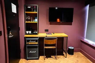 a bar in a purple room with a desk and a chair at Duke Street Boutique Hotel in Liverpool