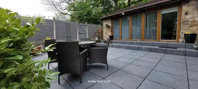 a patio with a table and chairs on a patio at Dean Clough Lodge - Contemporary self contained studio in Wilpshire