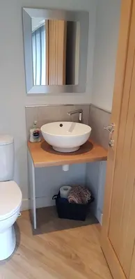 a bathroom with a sink and a toilet at Dean Clough Lodge - Contemporary self contained studio in Wilpshire