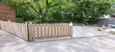 a wooden fence in front of a house at Dean Clough Lodge - Contemporary self contained studio in Wilpshire