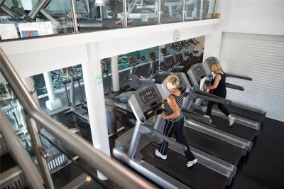 two people running on treadmills in a gym at 12 Borwick Lakes- Newly Refurbished in Carnforth