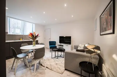 a living room with a couch and a table at Charles Alexander Short Stay - Windmill House Apartments in Lytham St Annes