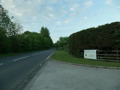 an empty road with a sign on the side of it at Low Greenlands Holiday Park - Luxury House & Luxury Glamping Pods in Lancaster