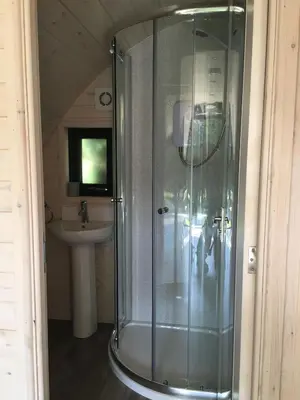 a glass shower in a bathroom with a sink at Low Greenlands Holiday Park - Luxury House & Luxury Glamping Pods in Lancaster