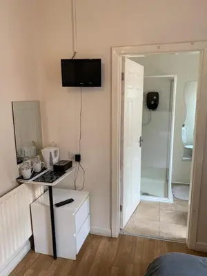 a room with a kitchen with a stove and a door at Alandene in Blackpool