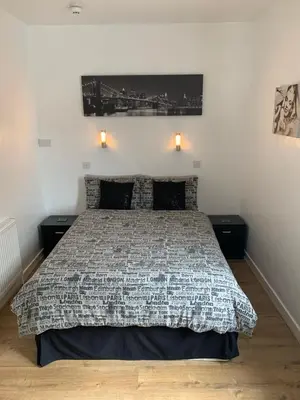 a bedroom with a bed with two night stands at Alandene in Blackpool