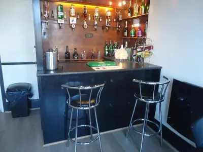 a bar with two bar stools in a room at Alandene in Blackpool