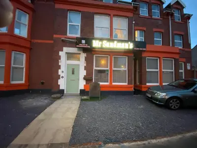 a car parked in front of a building at Mr sandman’s hotel in Blackpool