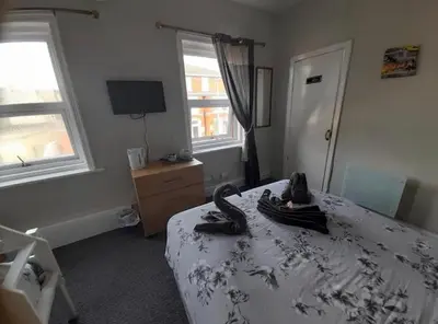 a bedroom with a bed with a snake on it at Mr sandman’s hotel in Blackpool