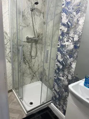 a shower with a glass door in a bathroom at Mr sandman’s hotel in Blackpool