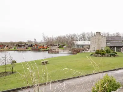 a view of a body of water with houses at Doormouse Lodge in Carnforth