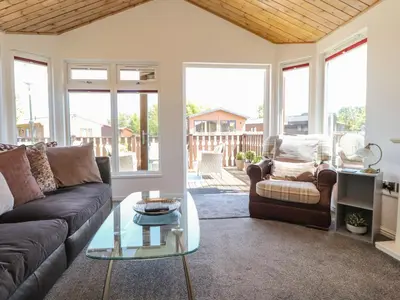 a living room with a couch and a table at Doormouse Lodge in Carnforth