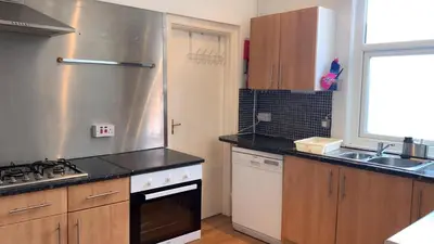 a kitchen with a sink and a stove top oven at Norwyn Court Holiday Apartments in Blackpool