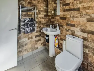 a bathroom with a toilet and a sink at Sunnyside Cottage in Crossens