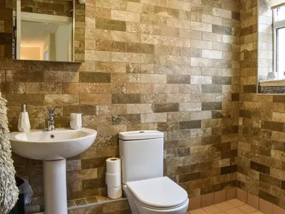 a bathroom with a toilet and a sink at Sunnyside Cottage in Crossens