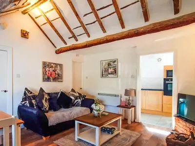 a living room with a couch and a table at Sunnyside Cottage in Crossens