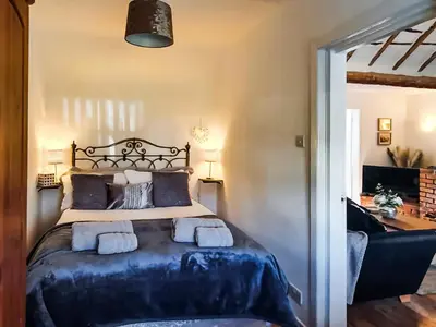 a bedroom with a bed with two towels on it at Sunnyside Cottage in Crossens