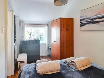 a bedroom with a bed with two pillows on it at Sunnyside Cottage in Crossens