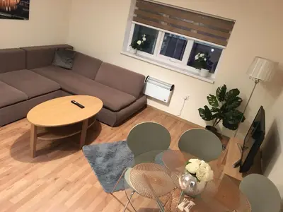 a living room with a couch and a table at Flats near football clubs in Liverpool