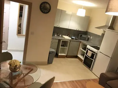 a kitchen with a table and a dining room at Flats near football clubs in Liverpool