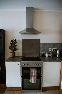 a kitchen with a stove top oven in a kitchen at Flats near football clubs in Liverpool