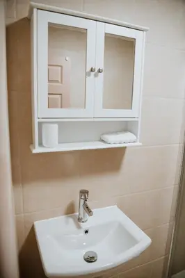 a bathroom with a sink and a medicine cabinet at Flats near football clubs in Liverpool