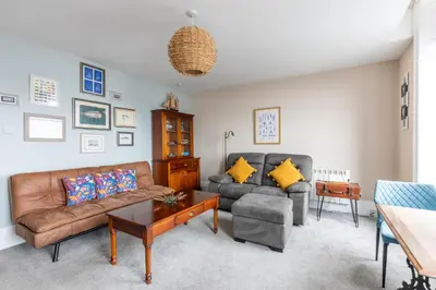 a living room with a couch and a table at BEACH VIEW - Amazing Sea Views in Lytham St Annes