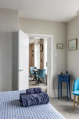 a bedroom with a bed and a blue table and chairs at BEACH VIEW - Amazing Sea Views in Lytham St Annes