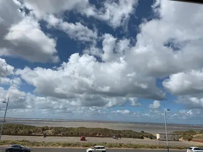 a cloudy sky with cars on a road at BEACH VIEW - Amazing Sea Views in Lytham St Annes