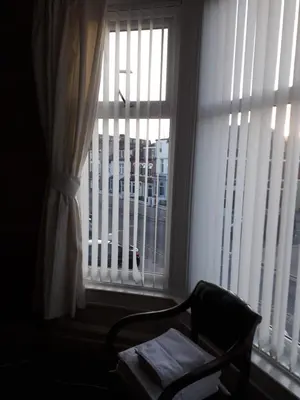 a chair sitting in front of a window with a view at Witton house in Blackpool