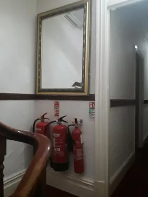 a mirror and three fire hydrants on a wall at Witton house in Blackpool