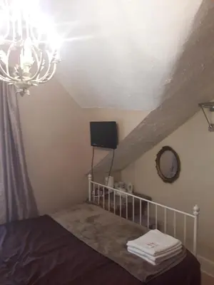 a bedroom with a bed and a chandelier at Witton house in Blackpool