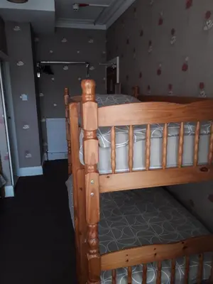 a wooden bunk bed in a childs bedroom at Witton house in Blackpool